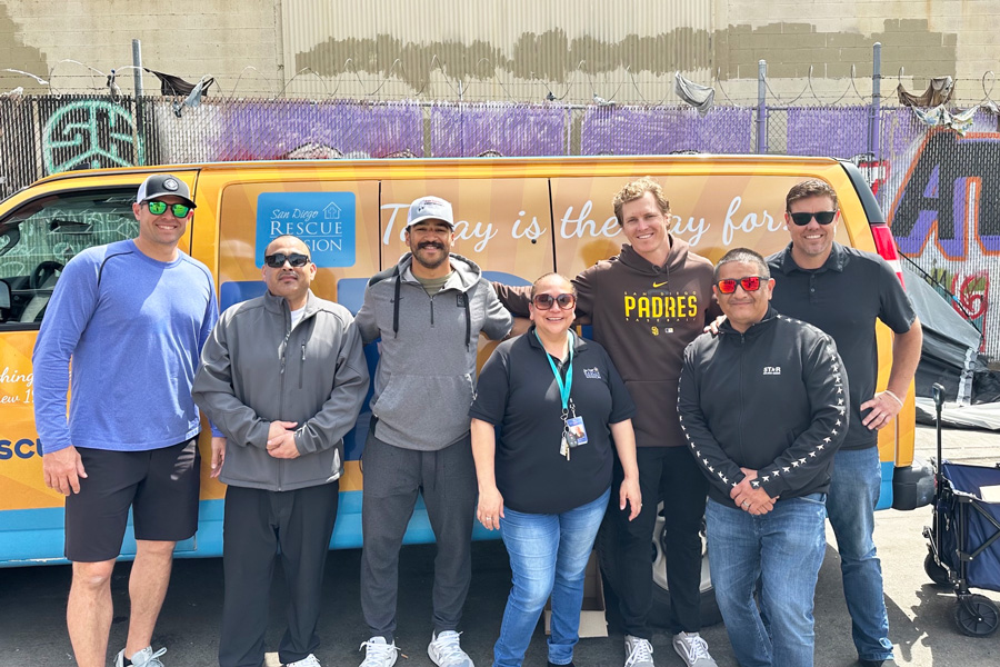 people in front of a van in downtown San Diego