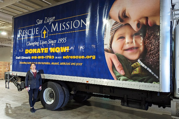 woman in front of blue truck