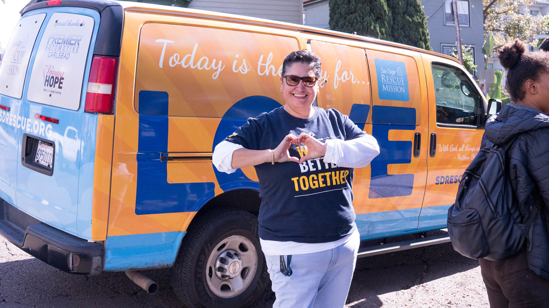 Woman in front of van labeled love